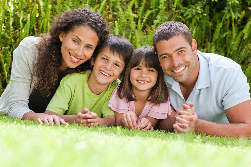 Happy family lying down in the garden